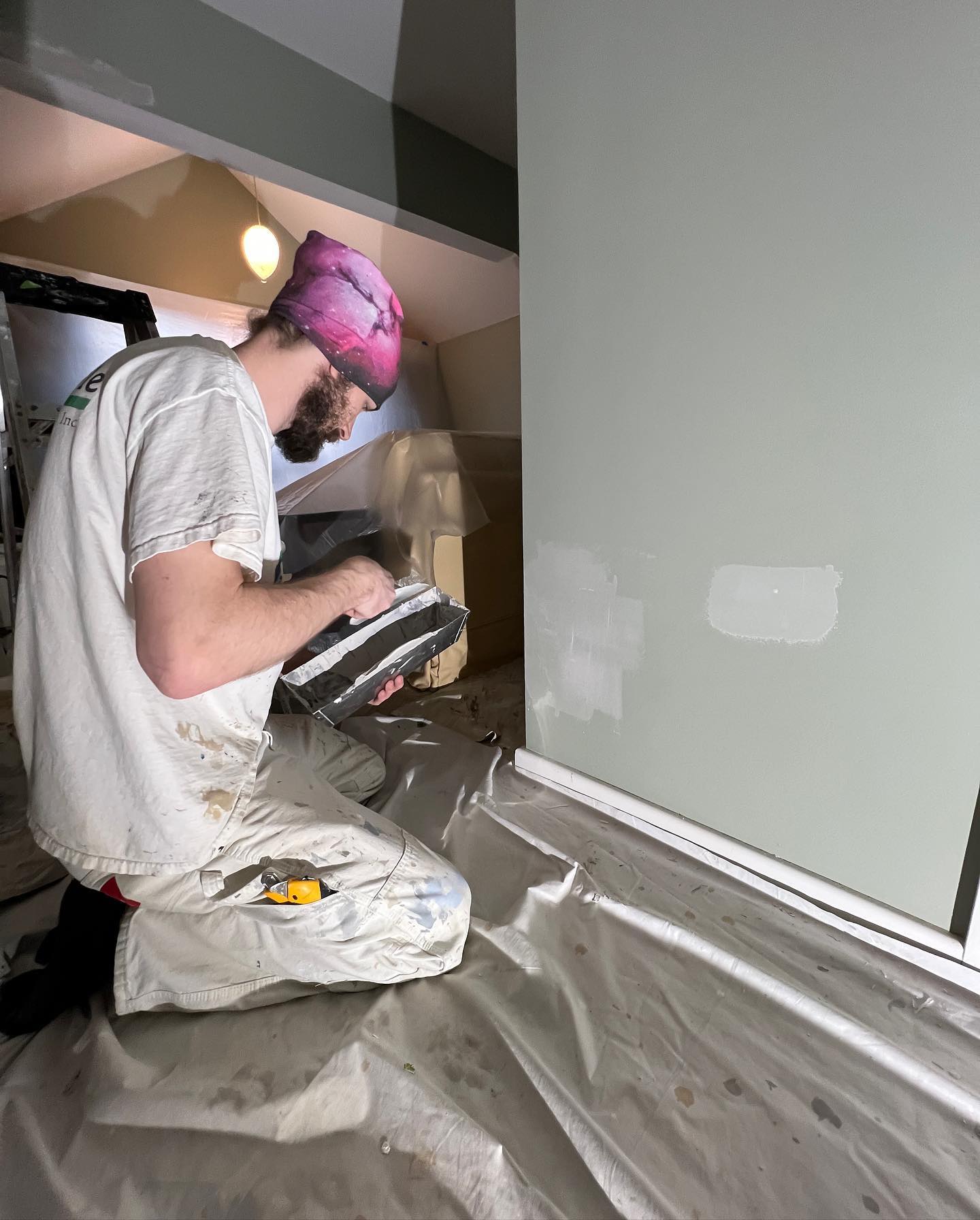 A Tribble Painting employee works on applying chalk paint to a wall.