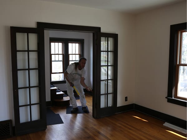 Aaron preparing interior wood trim for painting