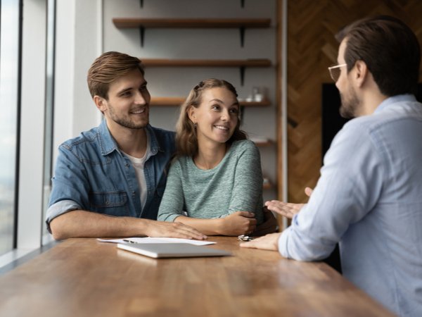 Couple talking to estimator during the process of hiring a painting contractor