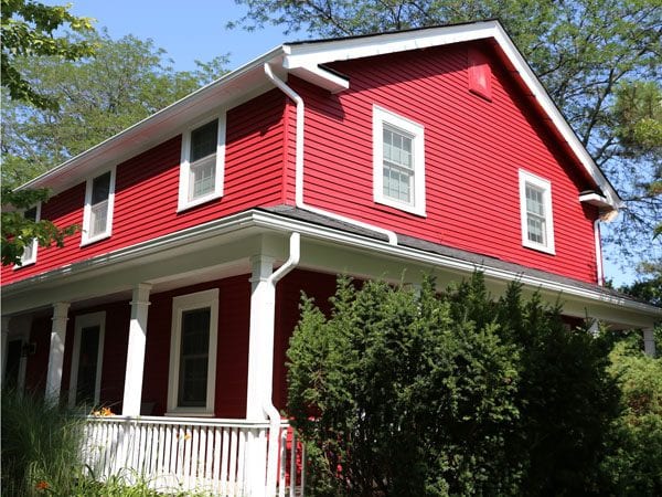 Front and side of home after painting aluminum siding