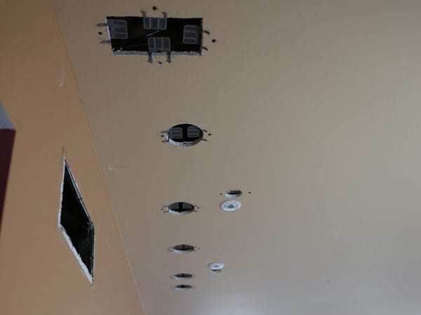 Holes in the ceiling left by lighting installation guy