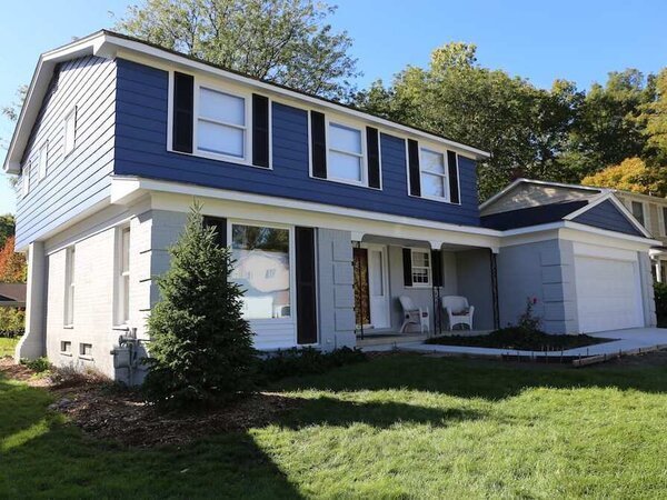House with an exterior that has the lower part white and upper part blue
