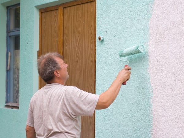Man painting with a roller.