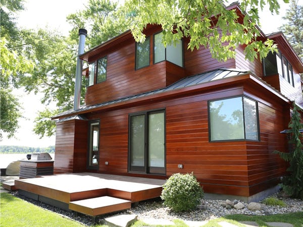 Other side of home with wood exterior siding after maintenance coating
