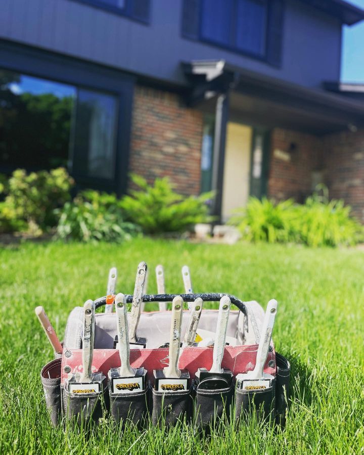 Paint brush holder in grass by house