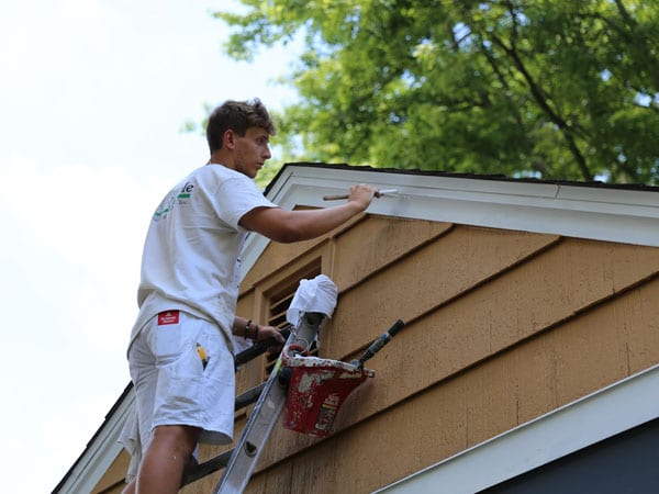 Painting trim on a house in Ann Arbor