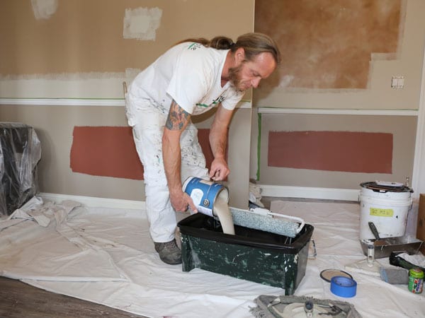 Pouring paint into a bucket