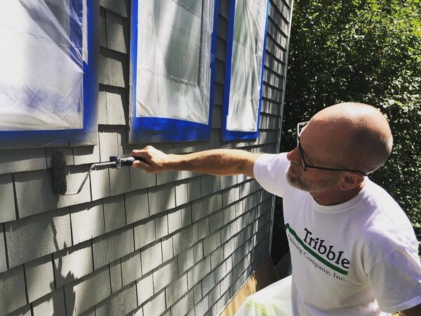 Todd Tribble painting a house exterior