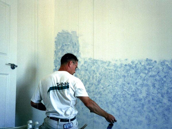 Tribble professional painting a wall