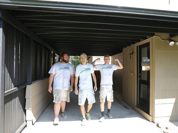 Tribble team after paint wood exterior carport in Ann Arbor