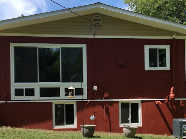 Back of red painted house with T1-11 siding