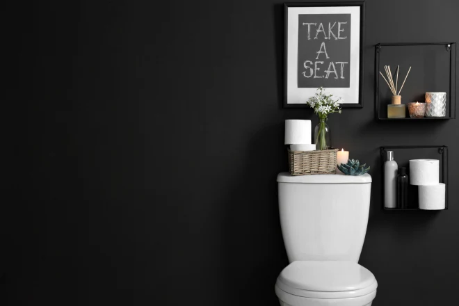 A bathroom with a matte black feature wall