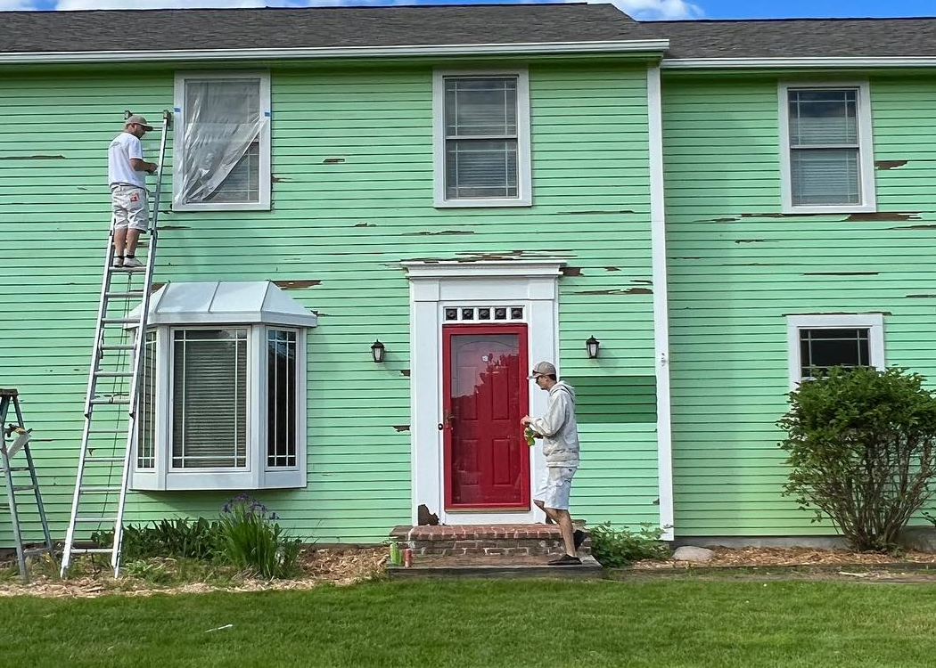 A home's exterior in the process of being painted