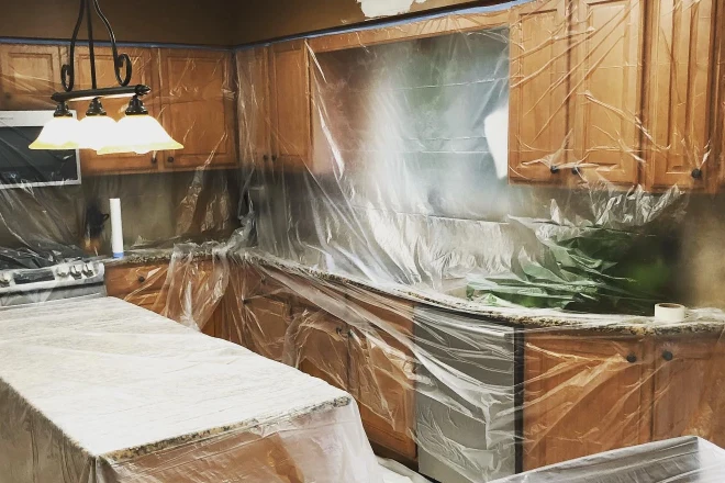 A kitchen protected with plastic traps and painters tape
