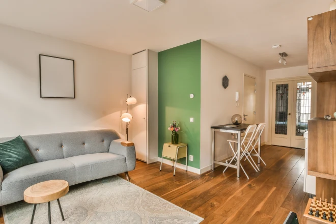 A living room with a small green accent wall
