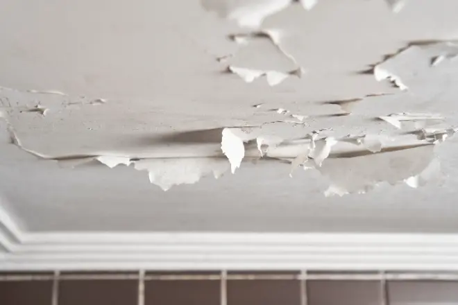 A peeling ceiling in a bathroom