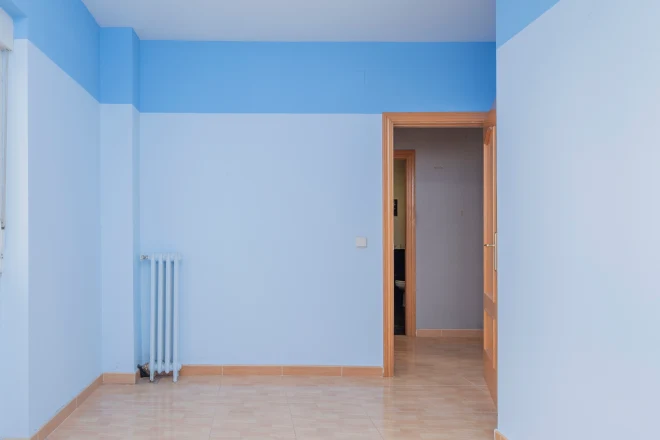 A room with a two tone horizon line painted on the wall