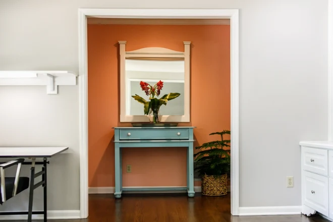 An orange colored feature wall in an entry way