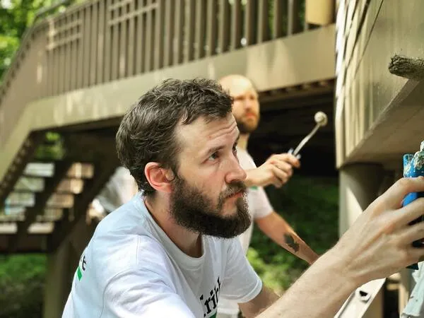 Tribble team member painting a home exterior