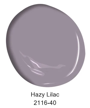 A paint swatch in a muted lavender shade labeled Hazy Lilac 2116-40, ideal for residential interior painting projects in Southeast Michigan communities like Ann Arbor, Ypsilanti, and Novi. Tribble Painting recommends this soft hue to create a calm and inviting atmosphere in your home. by Tribble Painting