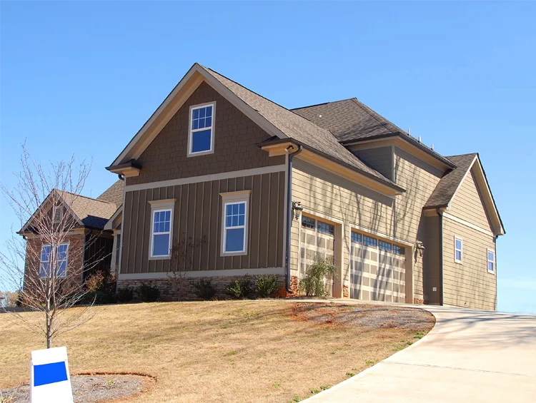 Exterior of a home painted brown up on a hill