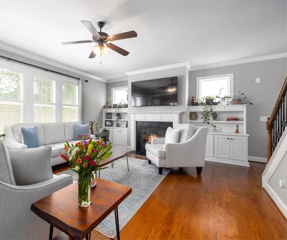 Living room with built ins and windows painted light blue