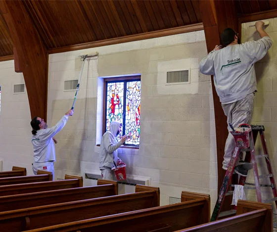 Tribble painters painting the interior of a church