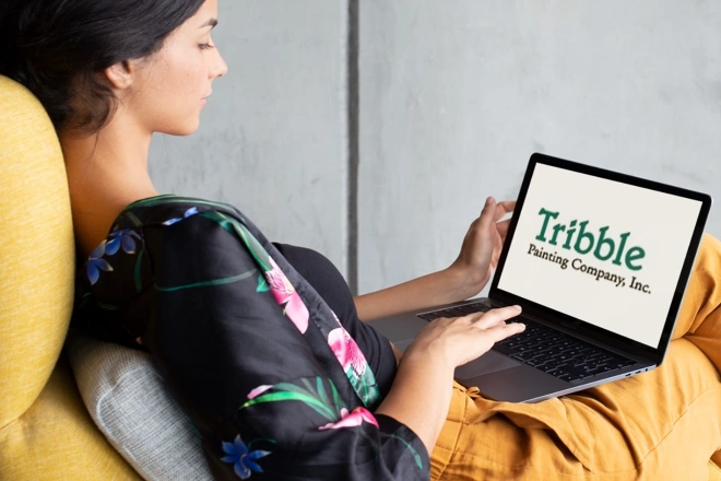 Person finding Tribble Painting Company online with their laptop computer.