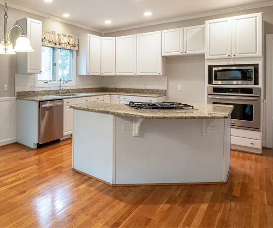 Freshly painted white cabinets in a smaller kitchen