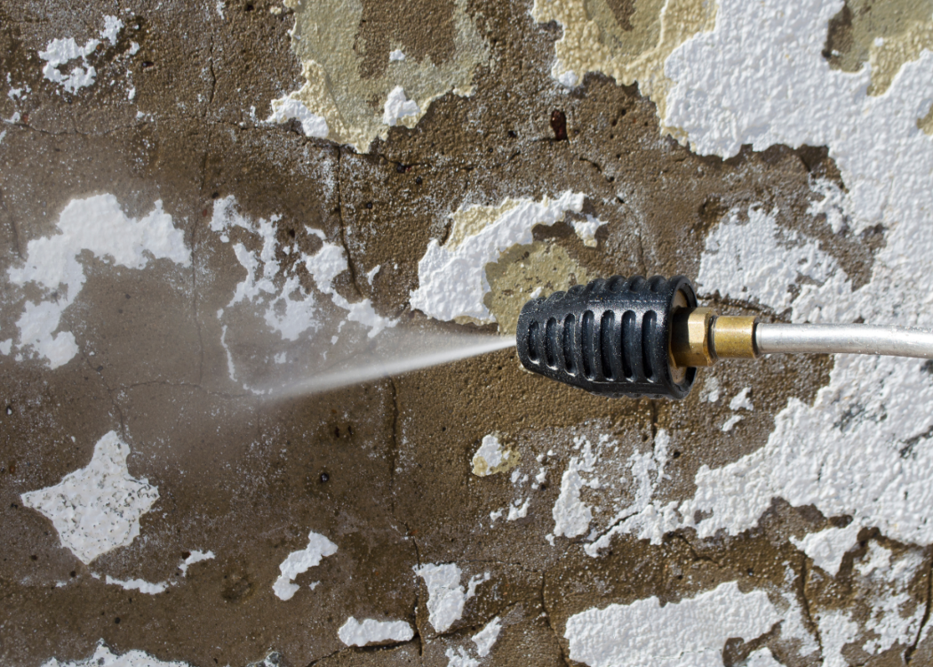 Power washer removing loose paint